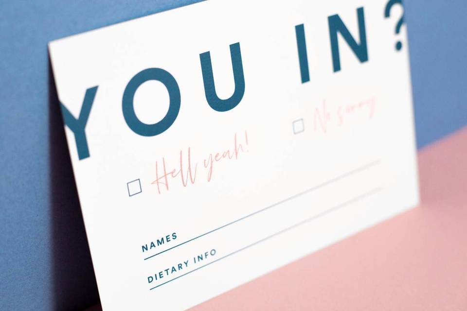 RSVP card for a wedding with modern typography and block colouring in blue reading 'you in?'
