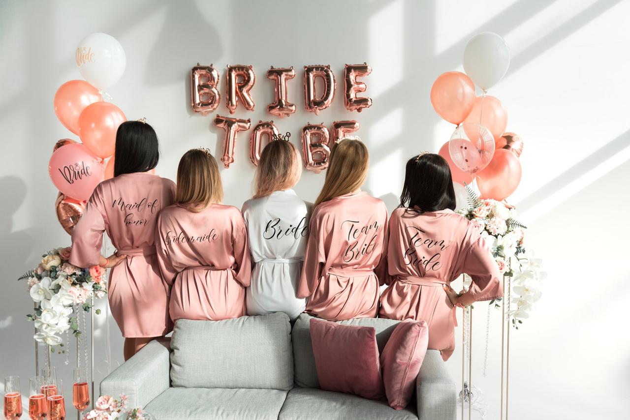 Bridesmaids and bride at a hen party with bride to be balloons