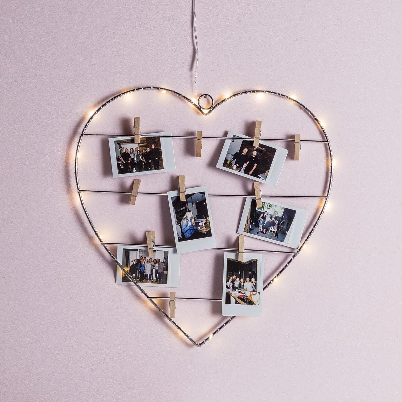 Light up wire heart with photos pegged on 