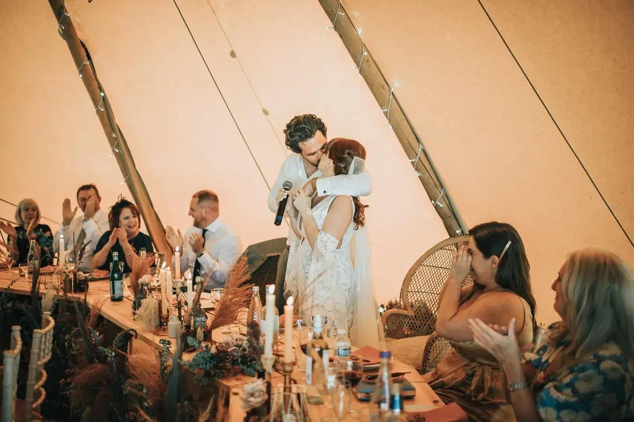 married couple kissing at toast