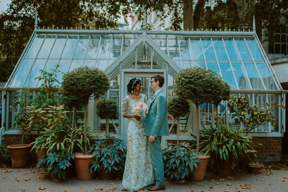 Nirosha and Dafydd outside a greenhouse