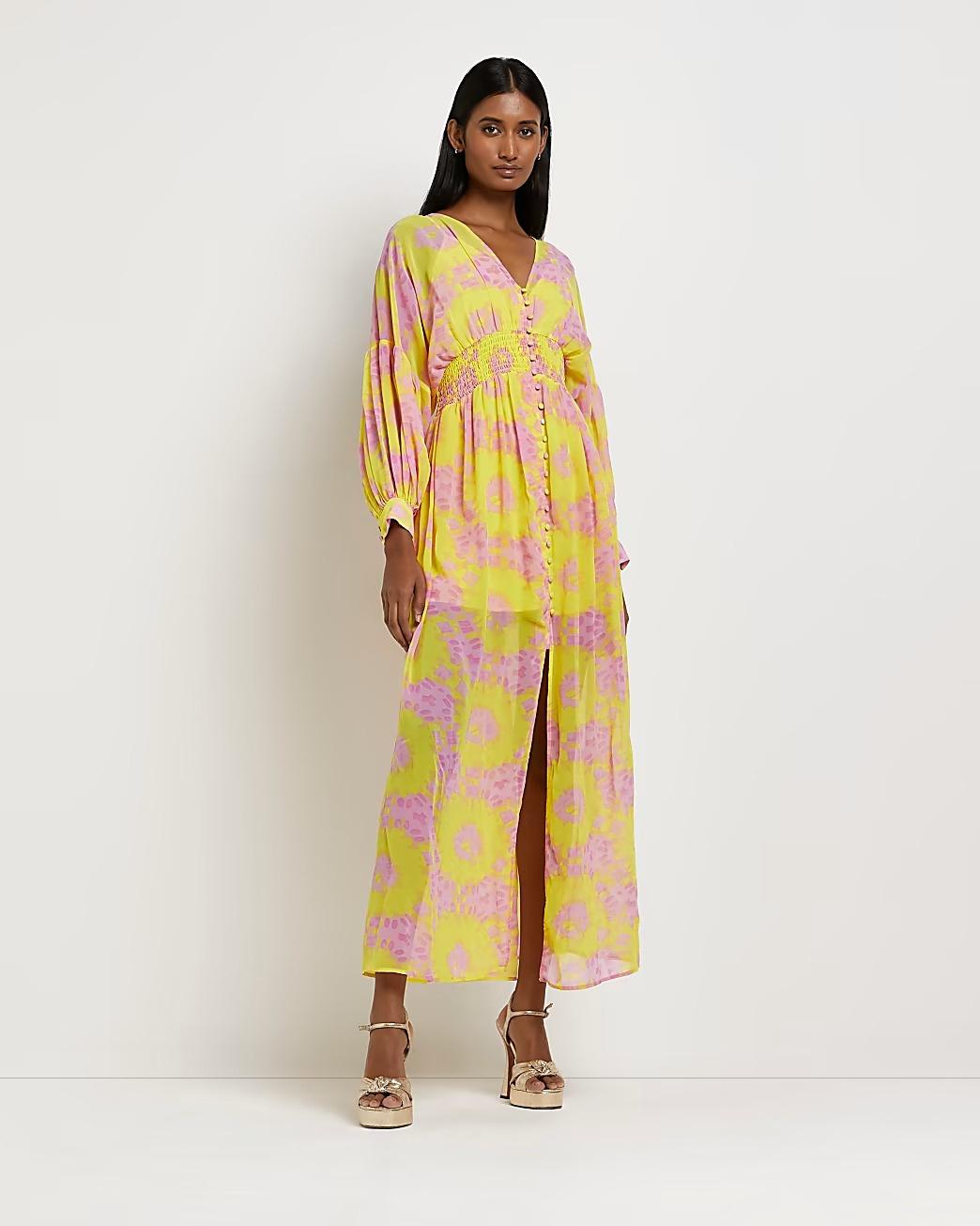 Model wearing a pink and yellow printed long sleeve dress