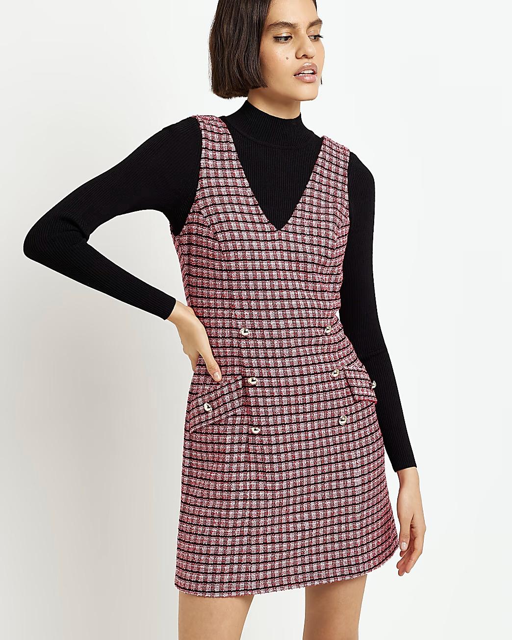 Model wearing a mink shift dress with a black long sleeved top