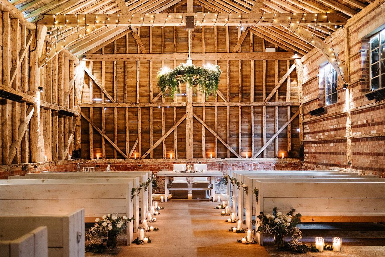 An indoor barn wedding with rustic woodland feel