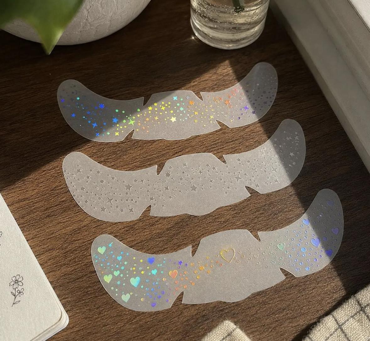 glitter freckles on three sheets laid out on a desk