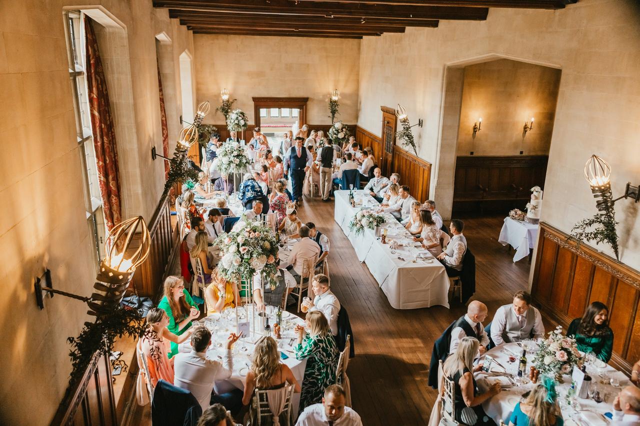 The tables with guests dining at the wedding reception