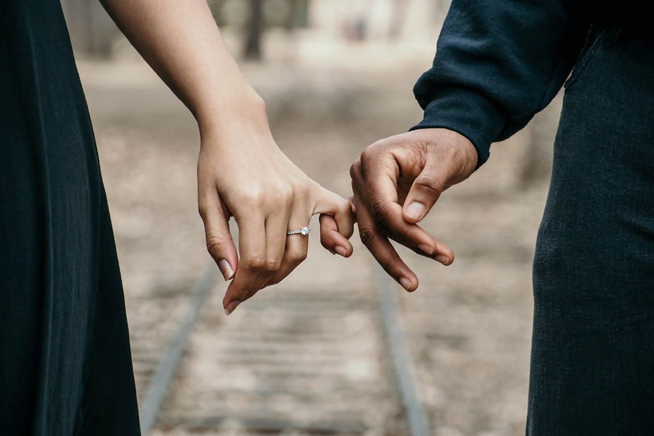 wedding and engagement ring on hand