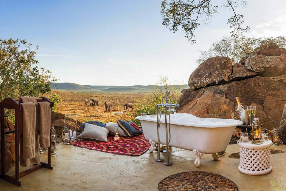 Aardvark Safaris view of romantic bath overlooking a game reserve