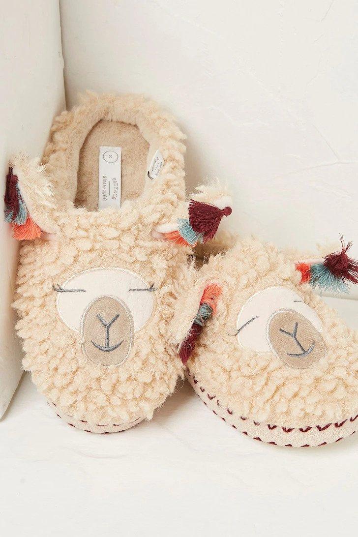 Fluffy slippers with a llama motif on them