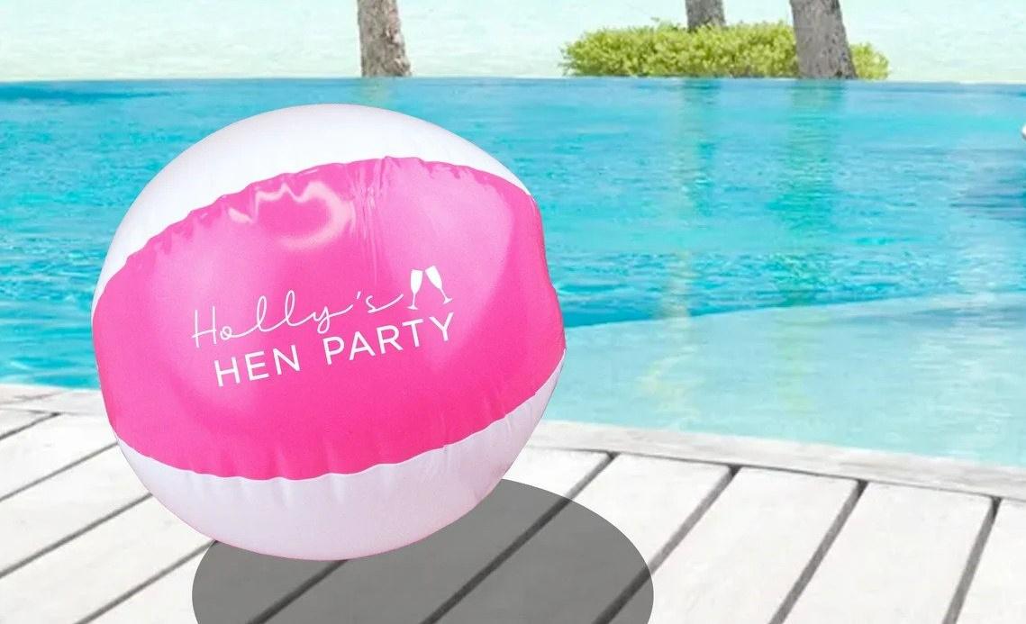 A pink and white Barbie beach ball
