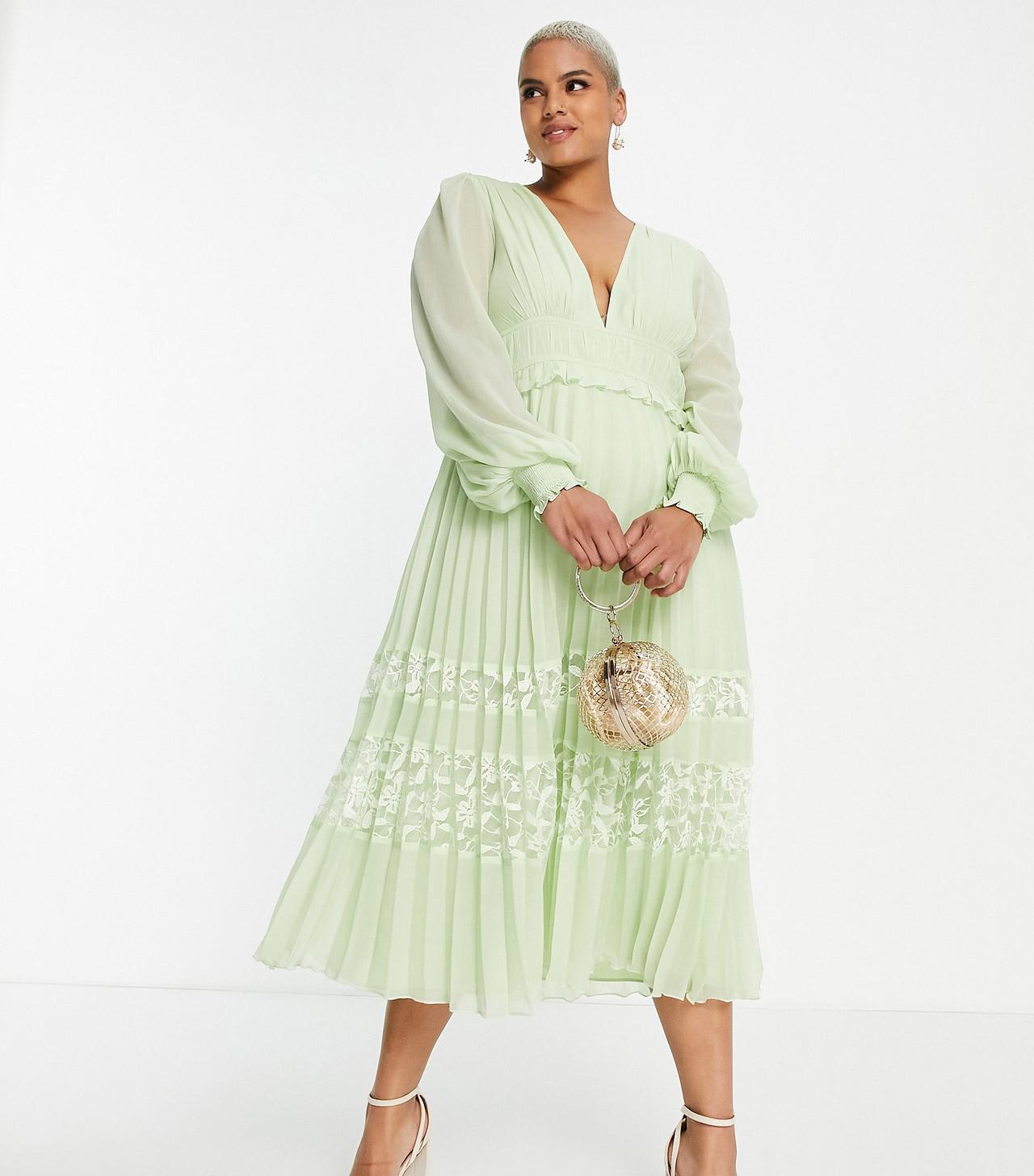 Model wearing a long sleeved light green pleated dress