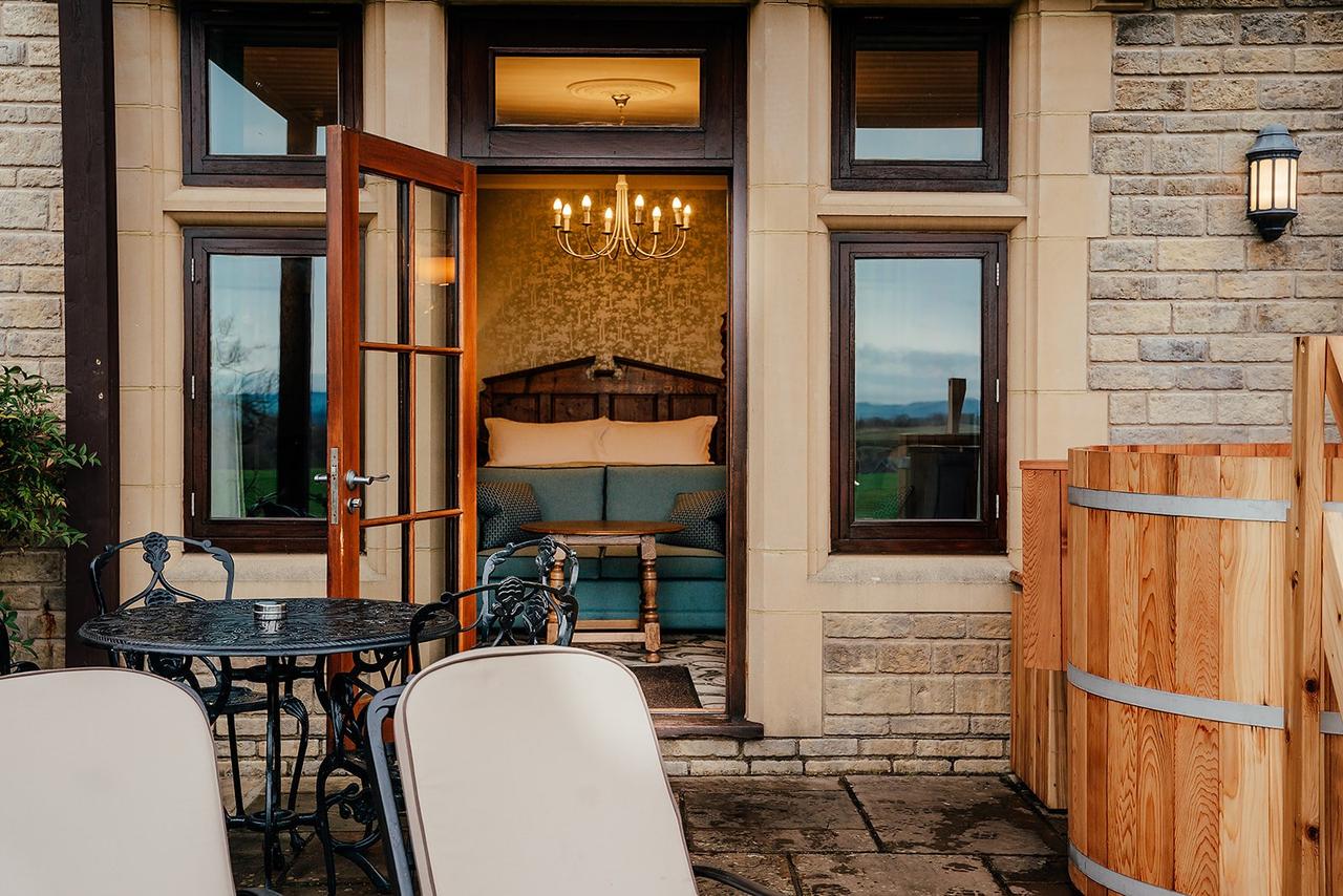 shot of a hotel bedroom at south lodge hotel in West Sussex, with an outdoor hot tub and shot of a bedroom
