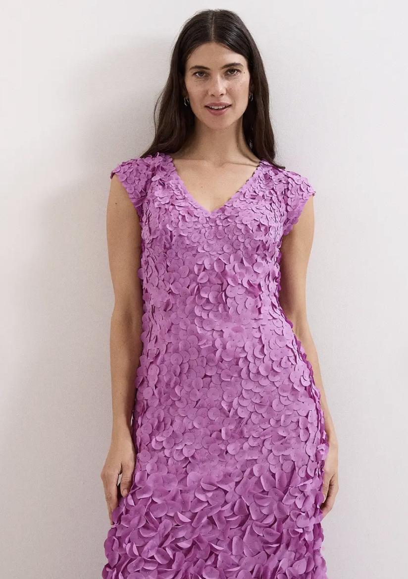 model wearing a magenta wedding guest dress decorated with petal appliques