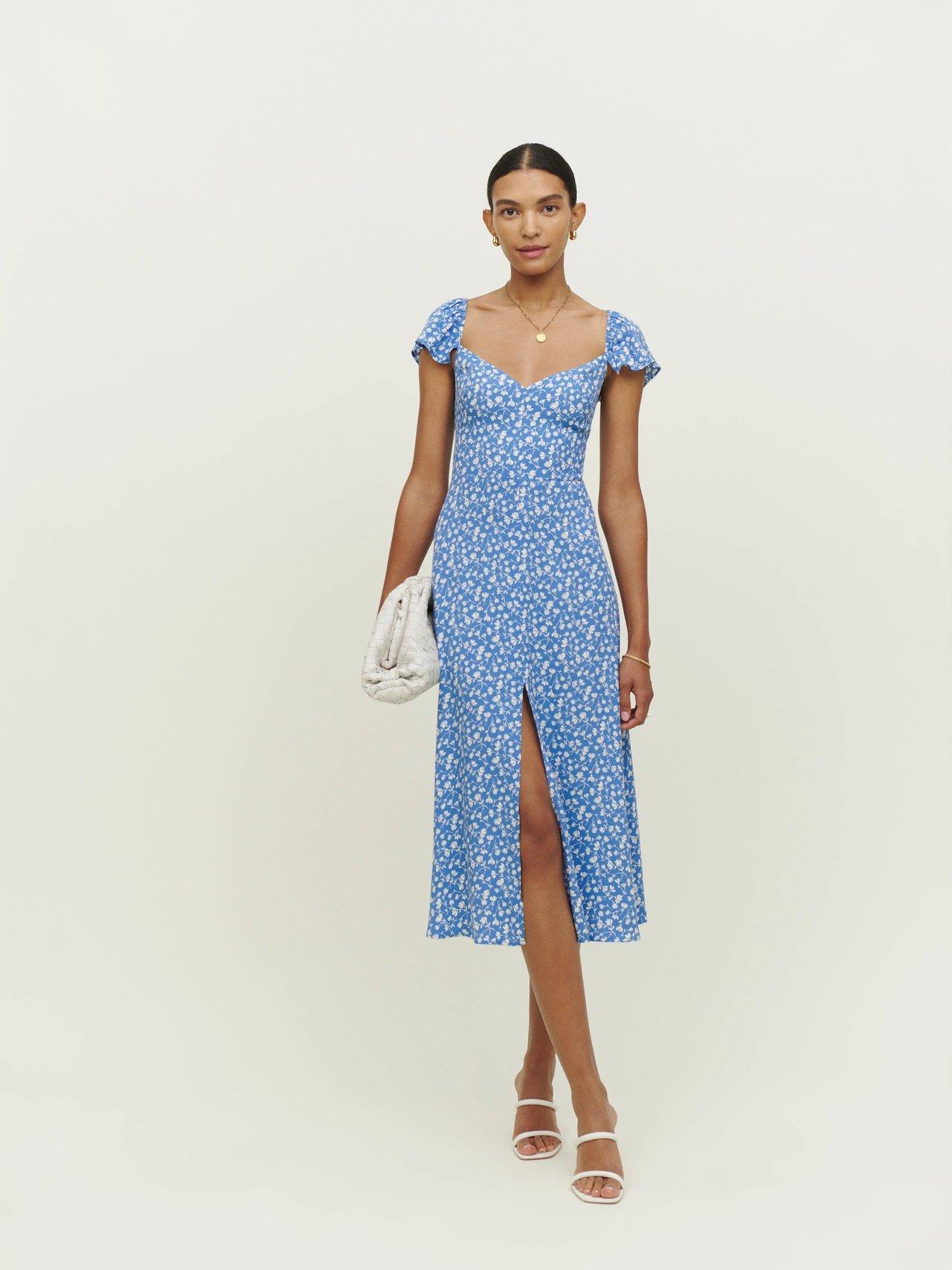 Model wearing a printed blue spring wedding guest dress