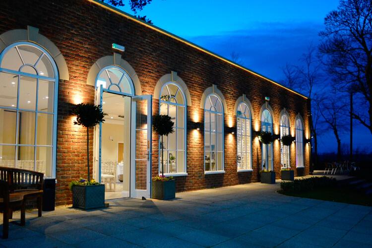 an outdoor view of the conservatory at Stallingborough Grange lit up at night