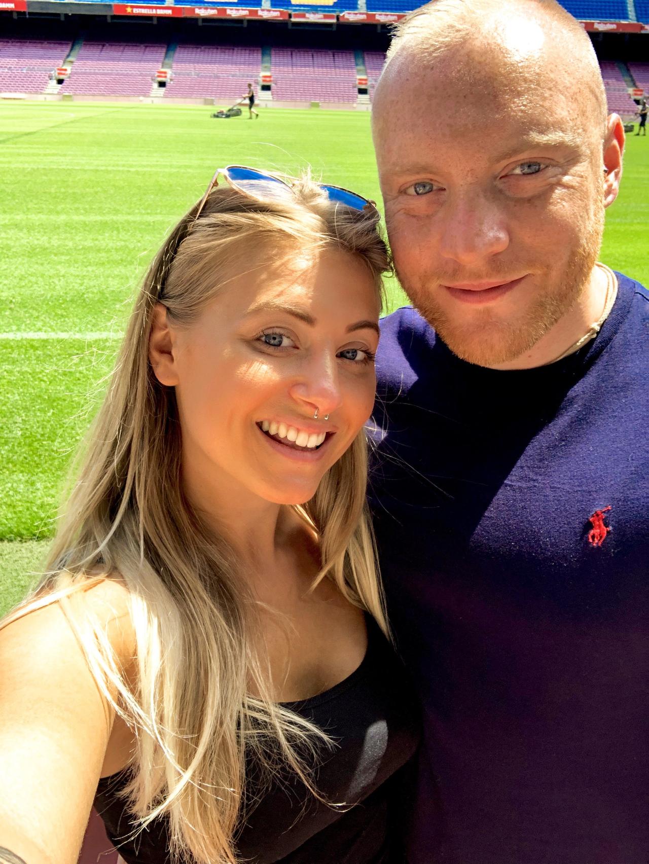 The writer and her fiance on a football pitch