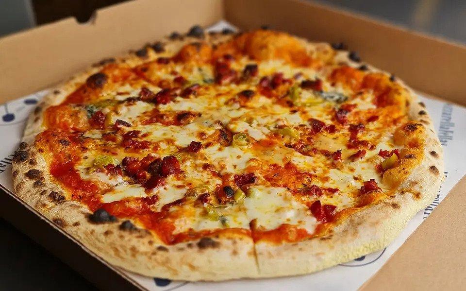 Vegetarian thin-crust pizza in pizza box
