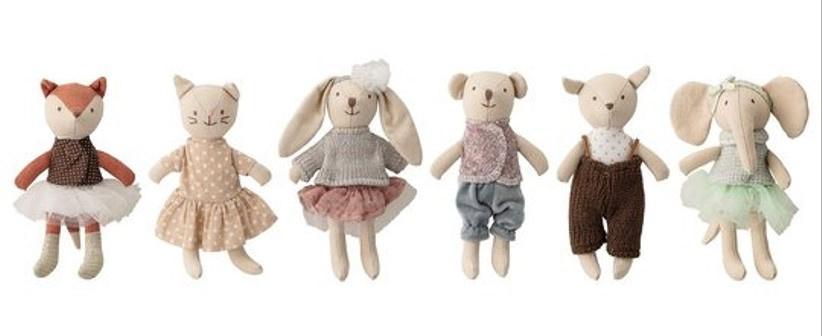 Soft plush toys of animals in little outfits for kids to take home after a wedding