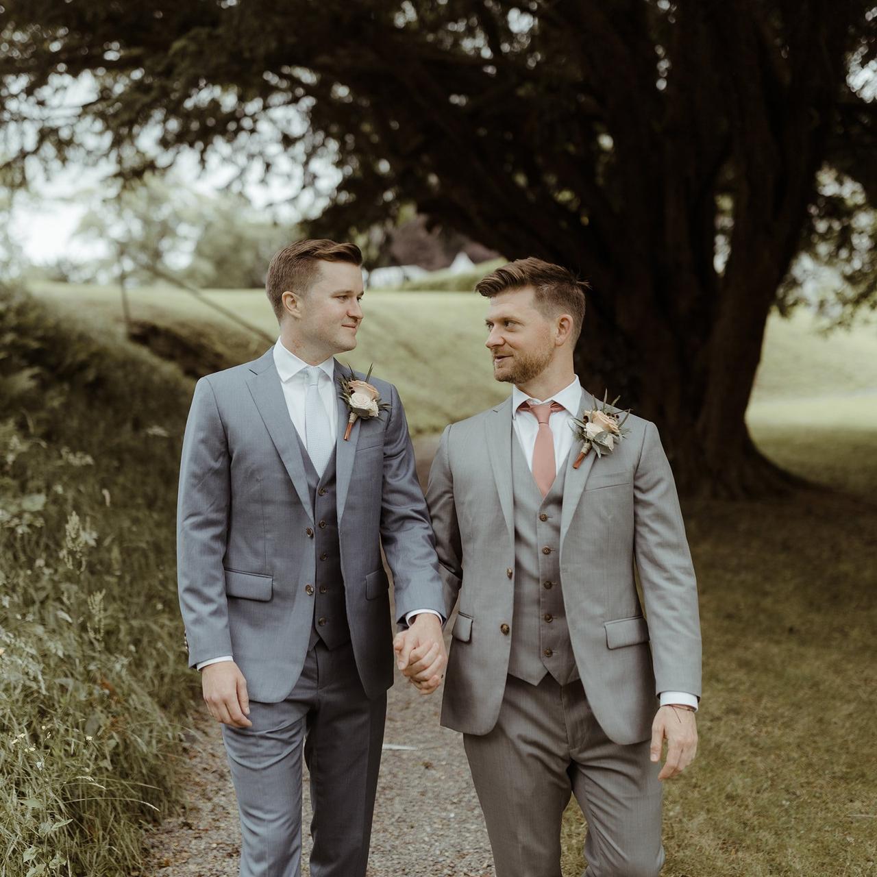 The grooms walk to the ceremony hand in hand