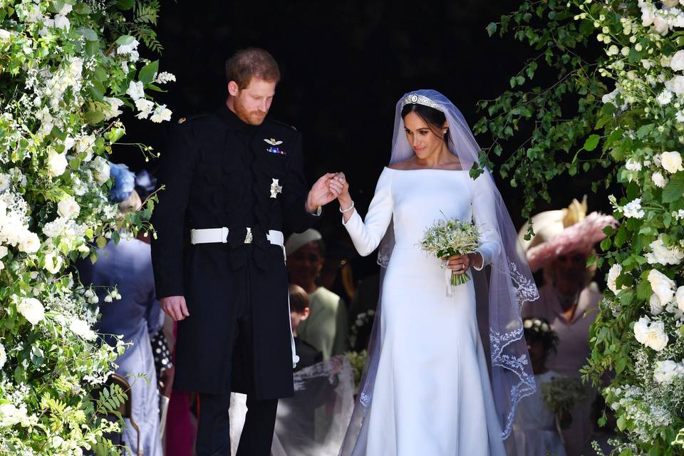 Meghan Markle and Prince Harry leaving their wedding ceremony with Meghan Markle wearing her iconic boat necked royal wedding dress