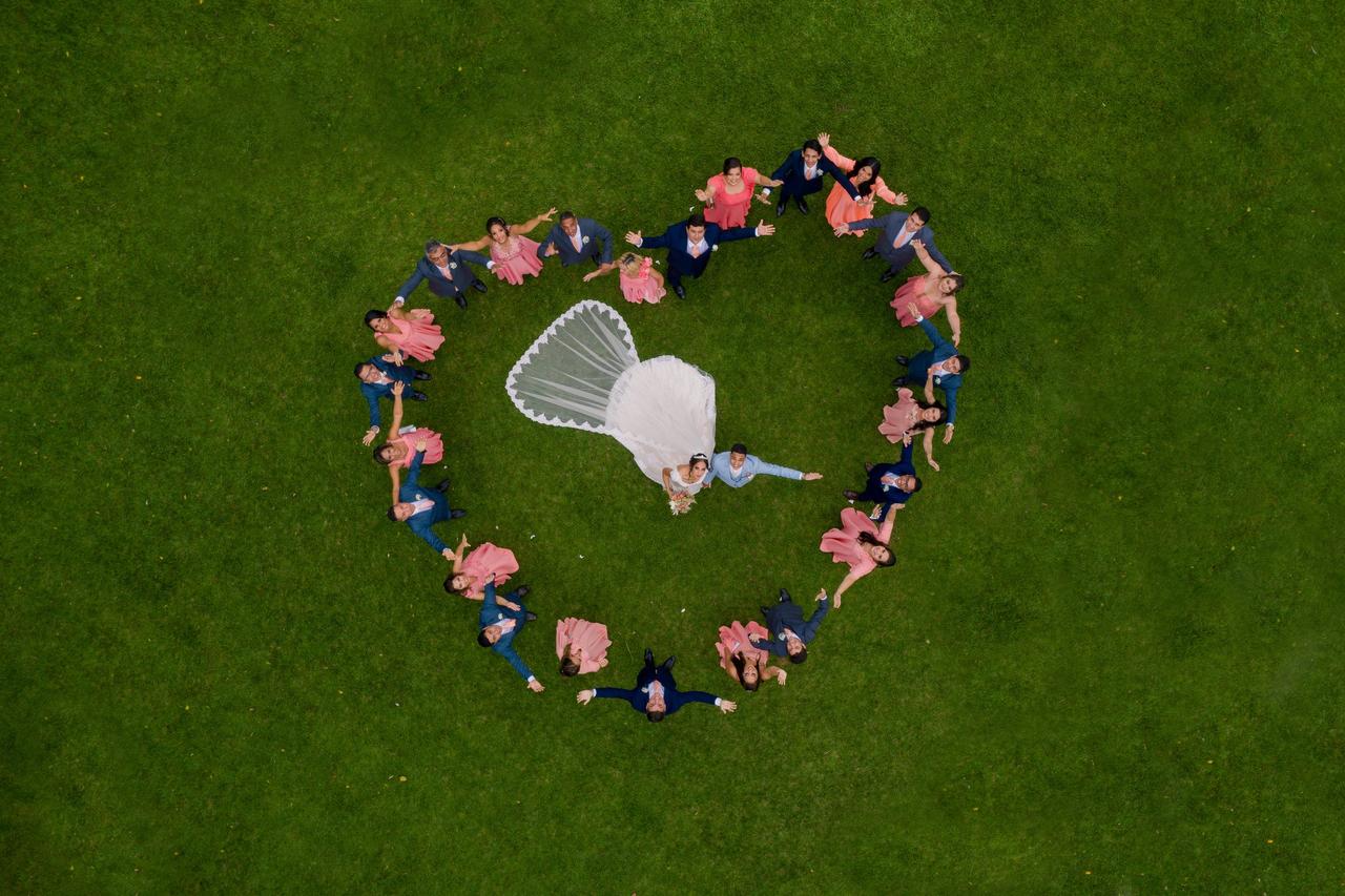 couple shot by a drone surrounded by friends and family