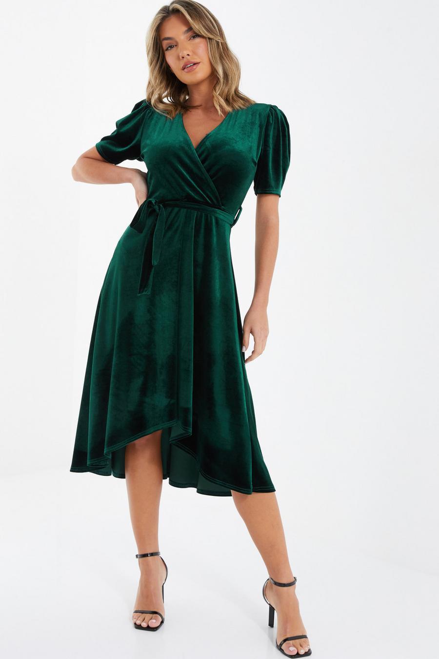 Model wearing a green velvet wrap bridesmaid dress
