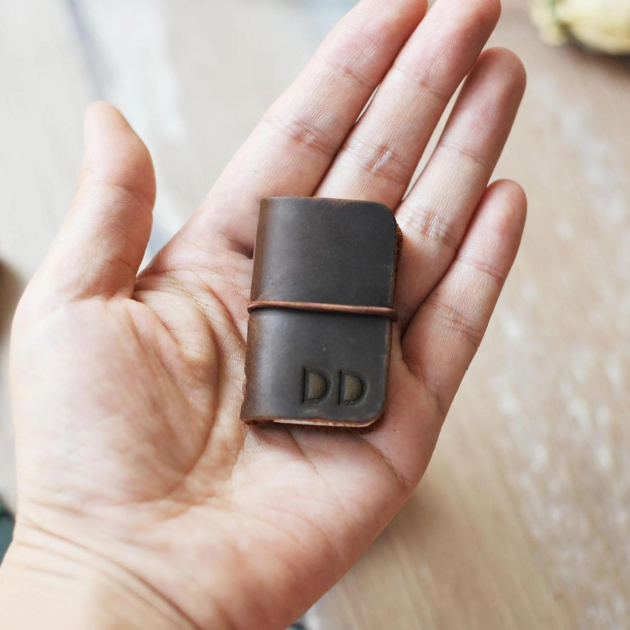 mini leather journal in hand
