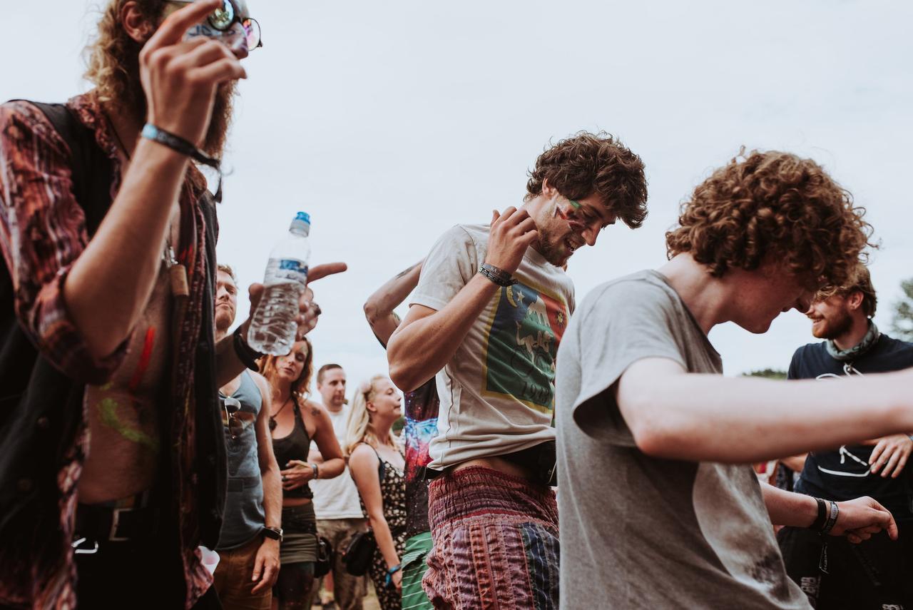 A group of stags at a festival dancing and having a great time in the crowd