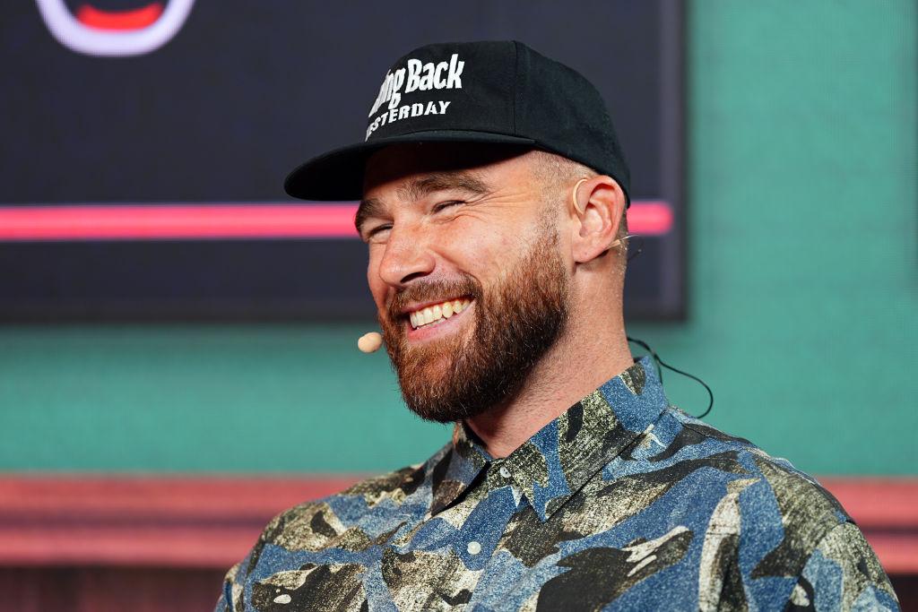 Travis Kelce smiling at the camera during an interview