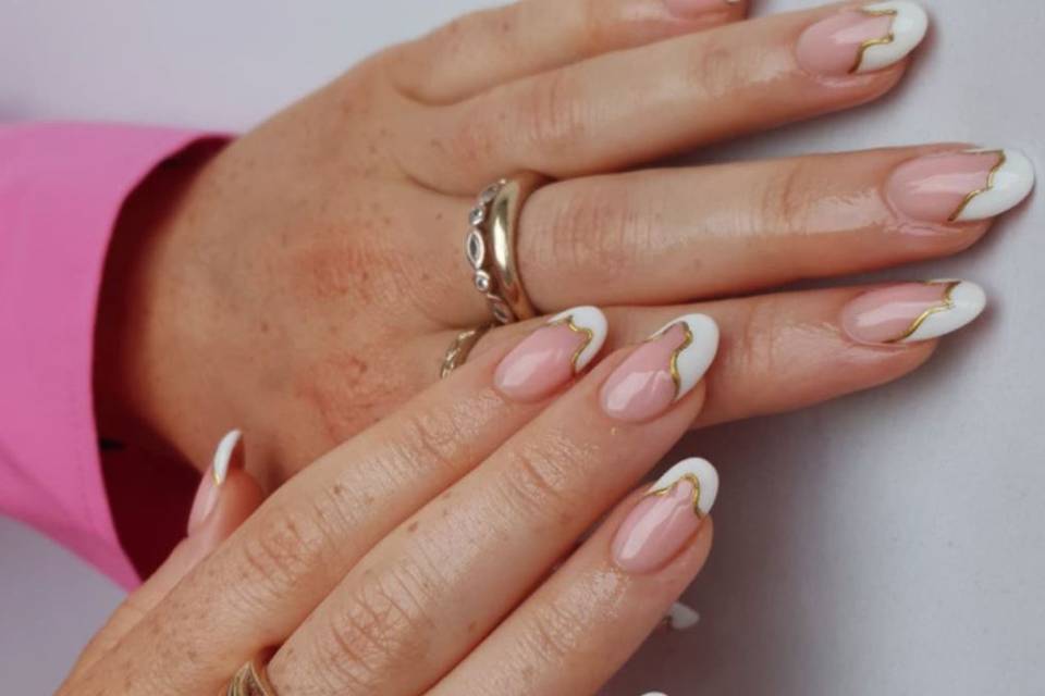 Nude wedding nails with swirly white tip lined with gold polish