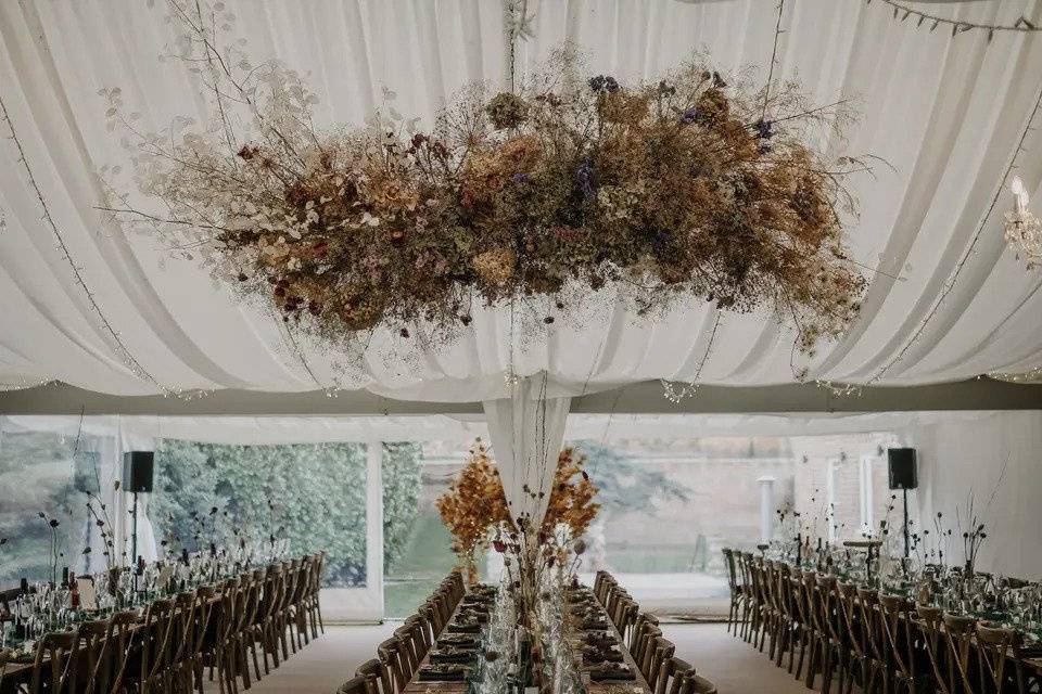 Marquee with long tables and floral decor