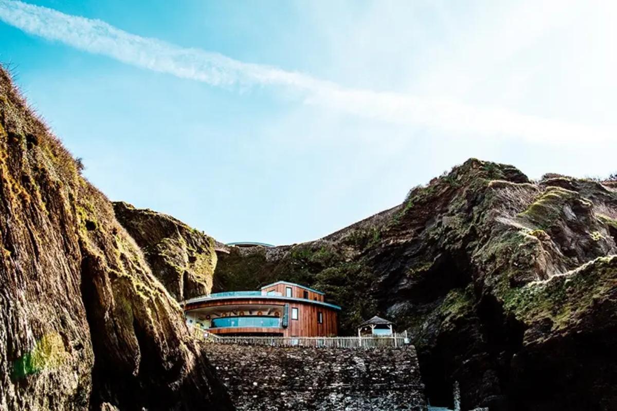 9 a shot of the beach wedding venue tunnels beaches which is sat within the rocks of a coastal cliff