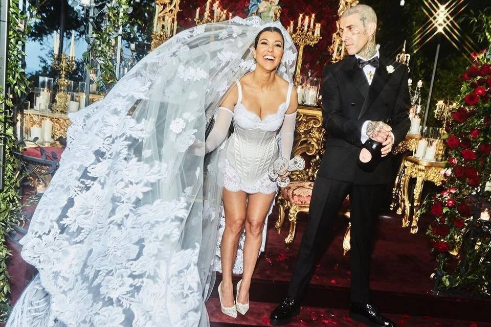 Kourtney Kardashian and Travis Barker at their Italian wedding surrounded by red roses