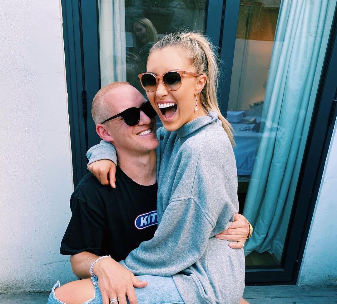 Sophie Habboo sat on Jamie Laing's lap both wearing sunglasses