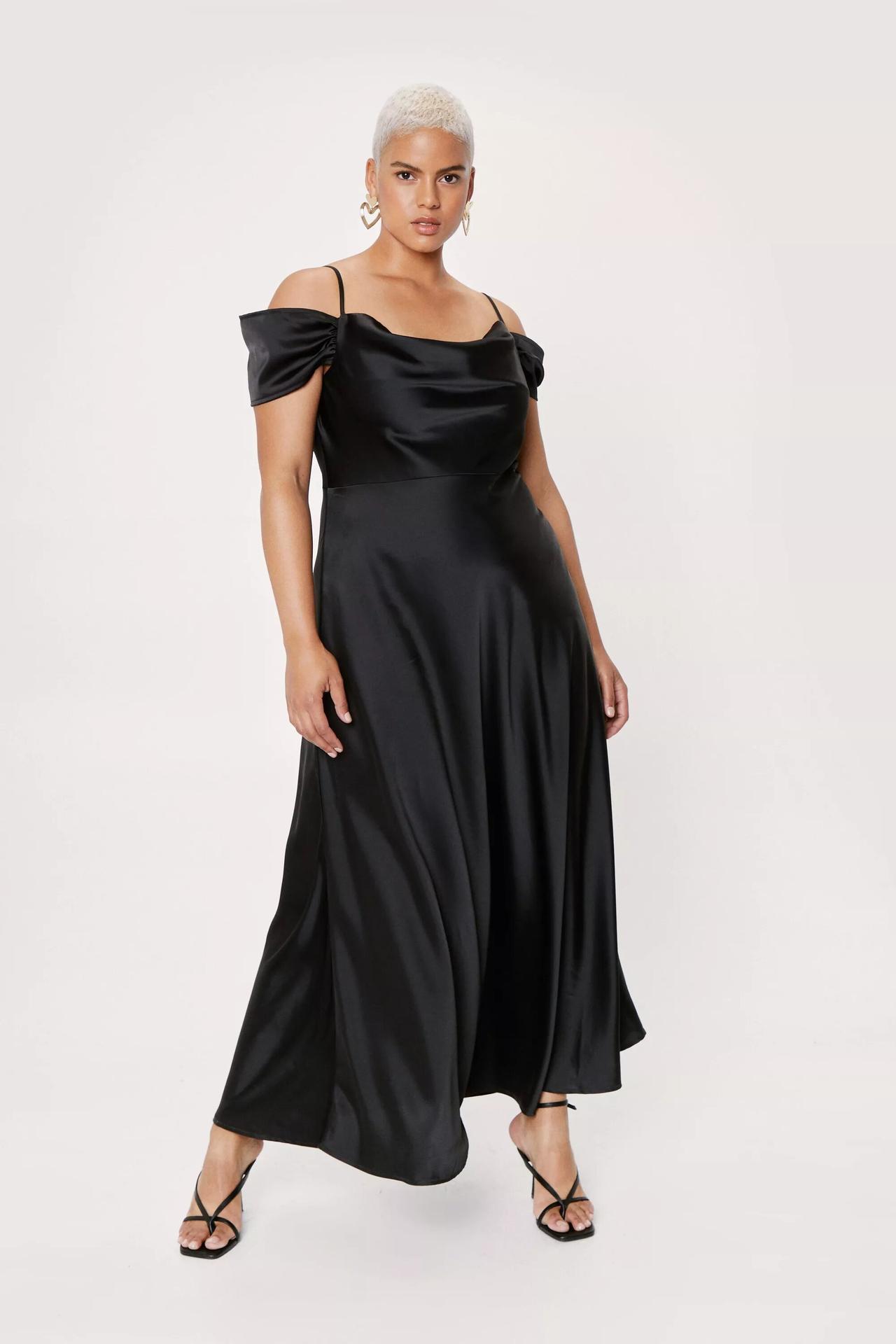 Model wearing a cowl neck cold shoulder black bridesmaid dress