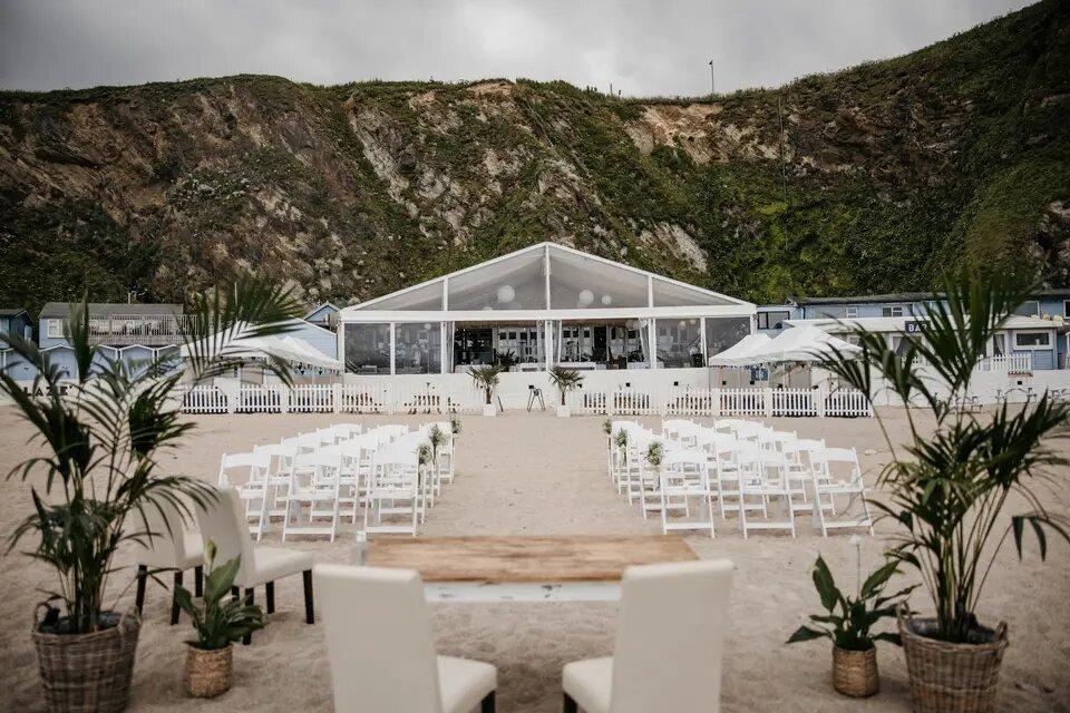 Wedding aisle on the beach decorated in palms