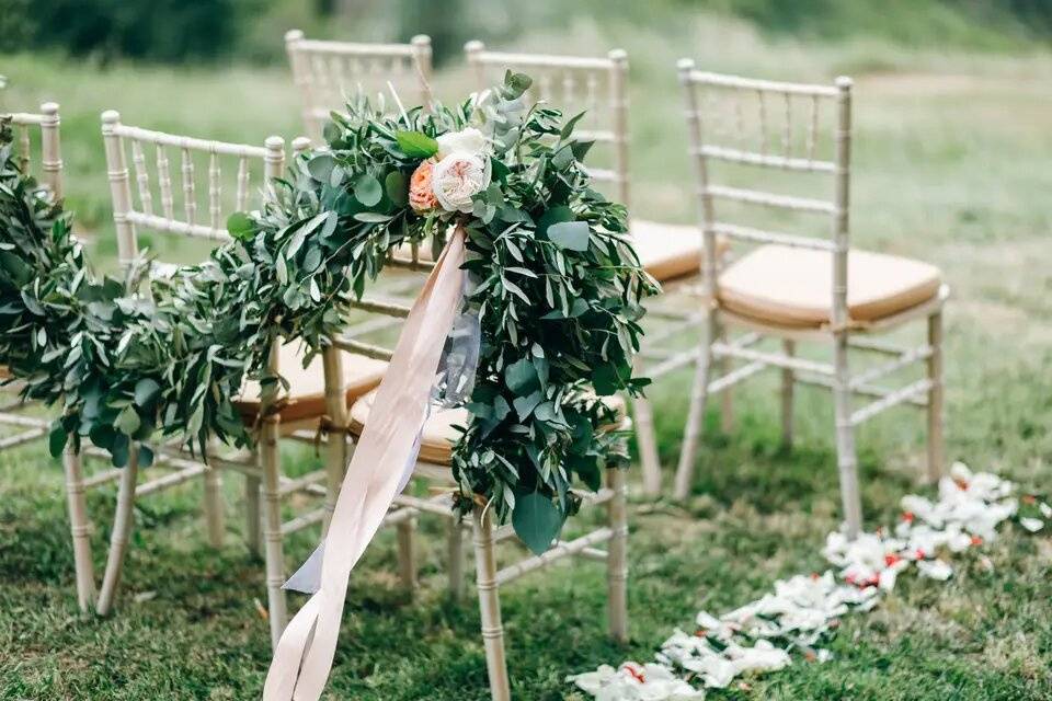 Greenery garland decorating wedding aisle chairs