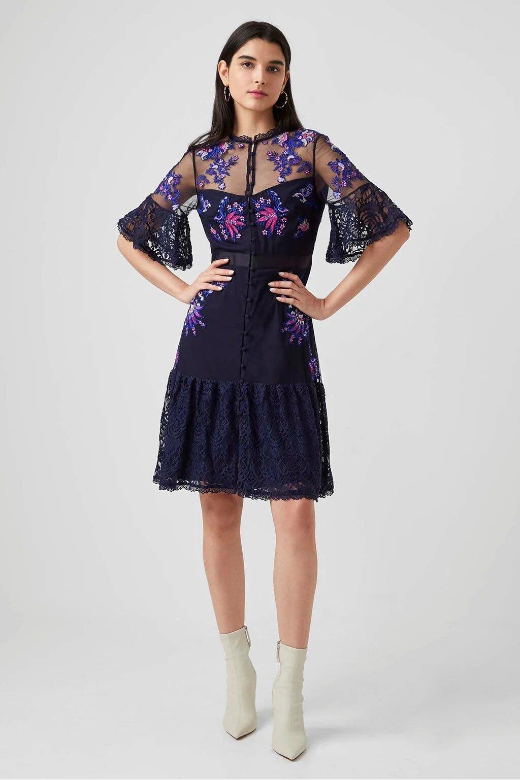 Model wearing a purple embroidered dress