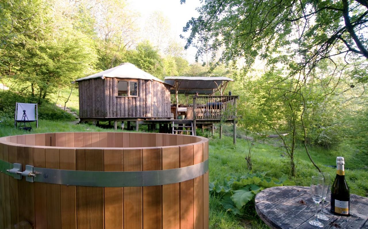 Wooden cabin rental in woodland with a wooden hot tub