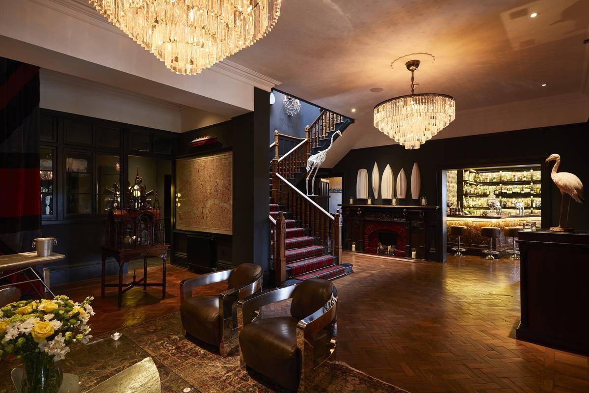 Wood floored small wedding venue lounge with chandeliers