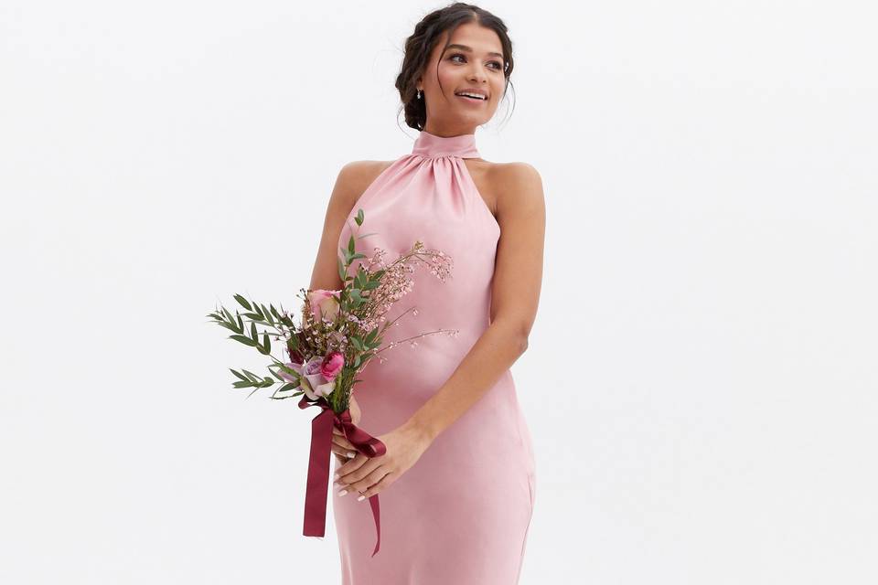 Model wearing a pink satin halter neck wedding dress 