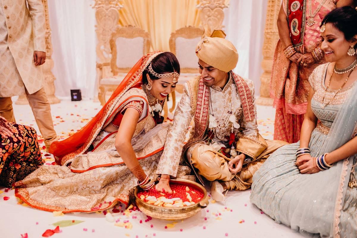 Bride and groom sitting crossed leg on the floor