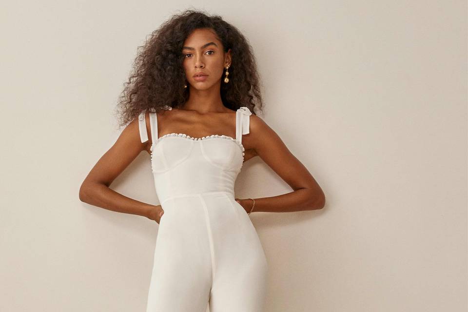 Model wearing a white bridal jumpsuit