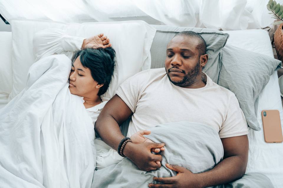 Couple asleep together in bed