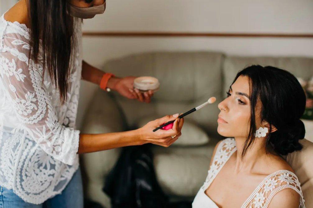 Bride with nude makeup having her highlighter applied