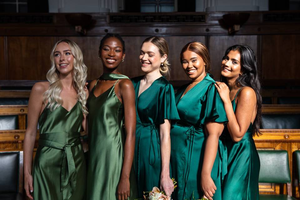 Models wearing satin green bridesmaid dresses