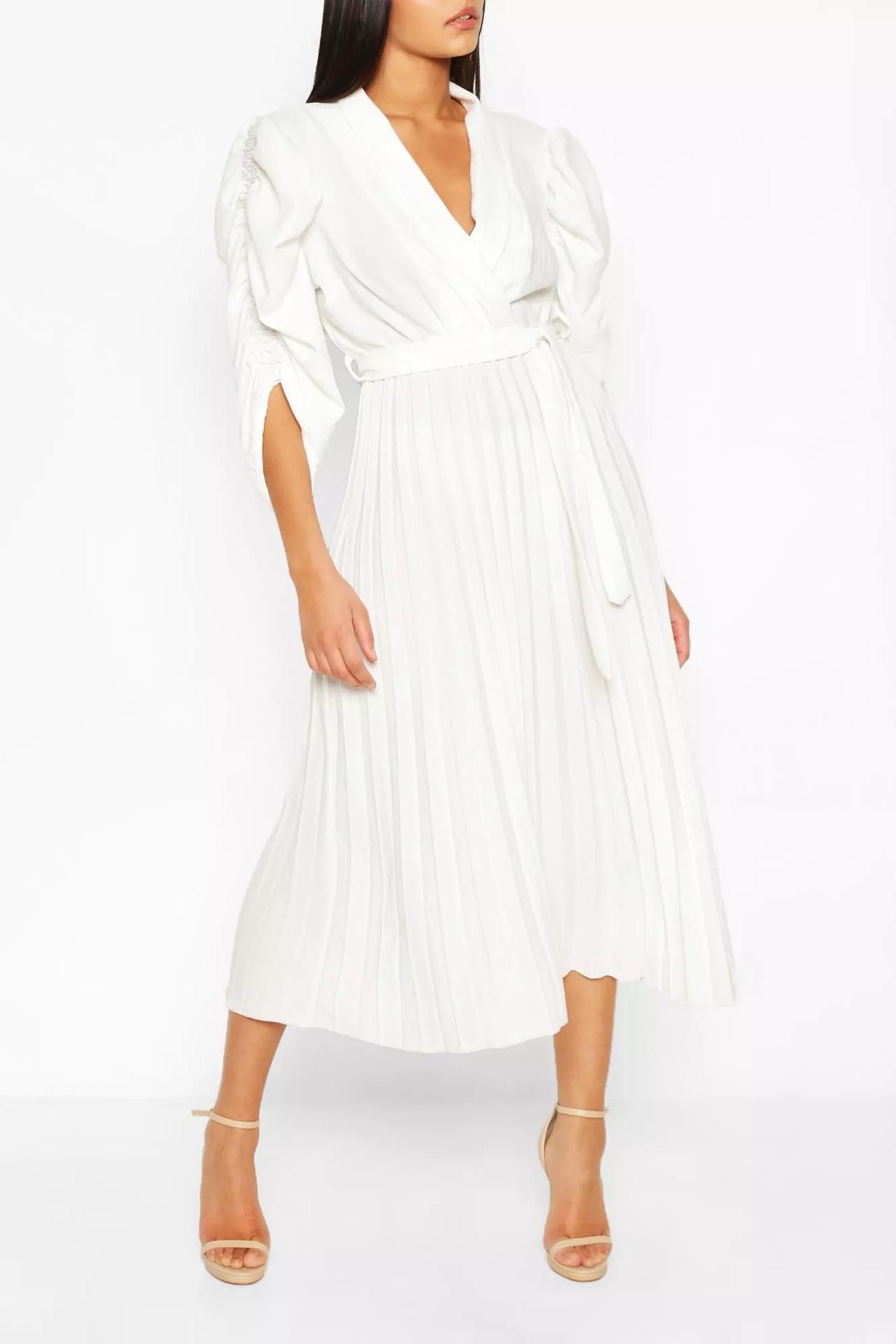 Model wearing a pleated skirt puff sleeve wedding dress