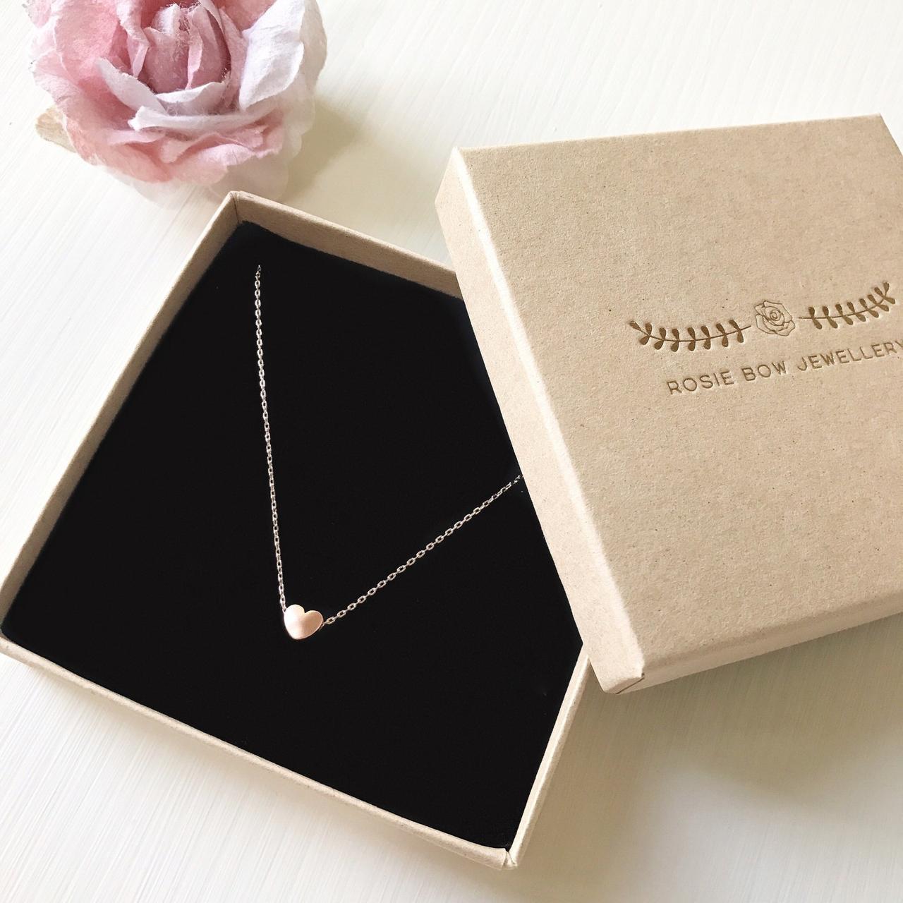A minimalist heart pendant with rose gold plating