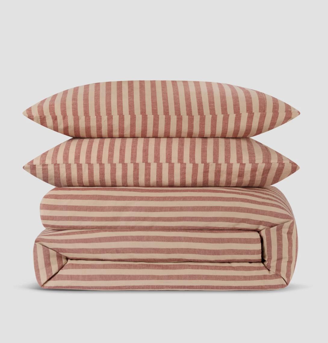 Piglet in bed pink striped bed sheets