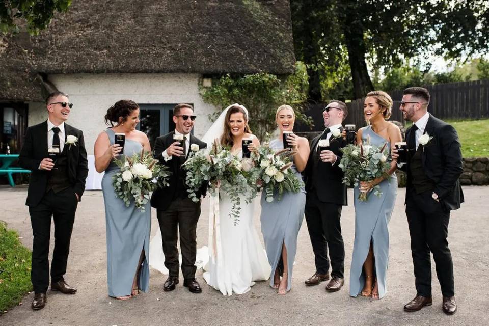 bridal party drinking guiness at northern ireland wedding venue